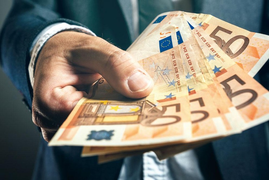 businessman from bank offering money loan in euro banknotes